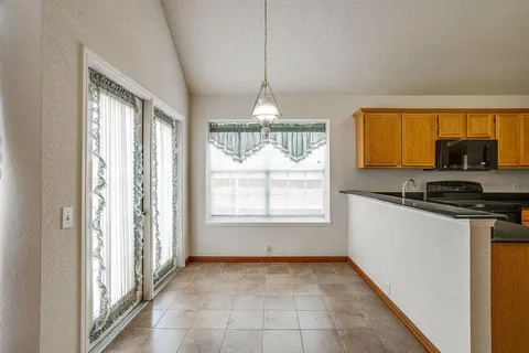 a kitchen that has a lot of windows and cabinets