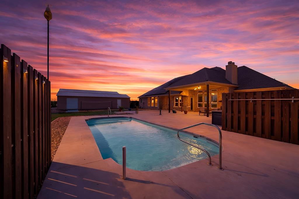 33’ x 14’ fiberglass pool, with dual stairs deck jets and waterfall! Virtually staged.