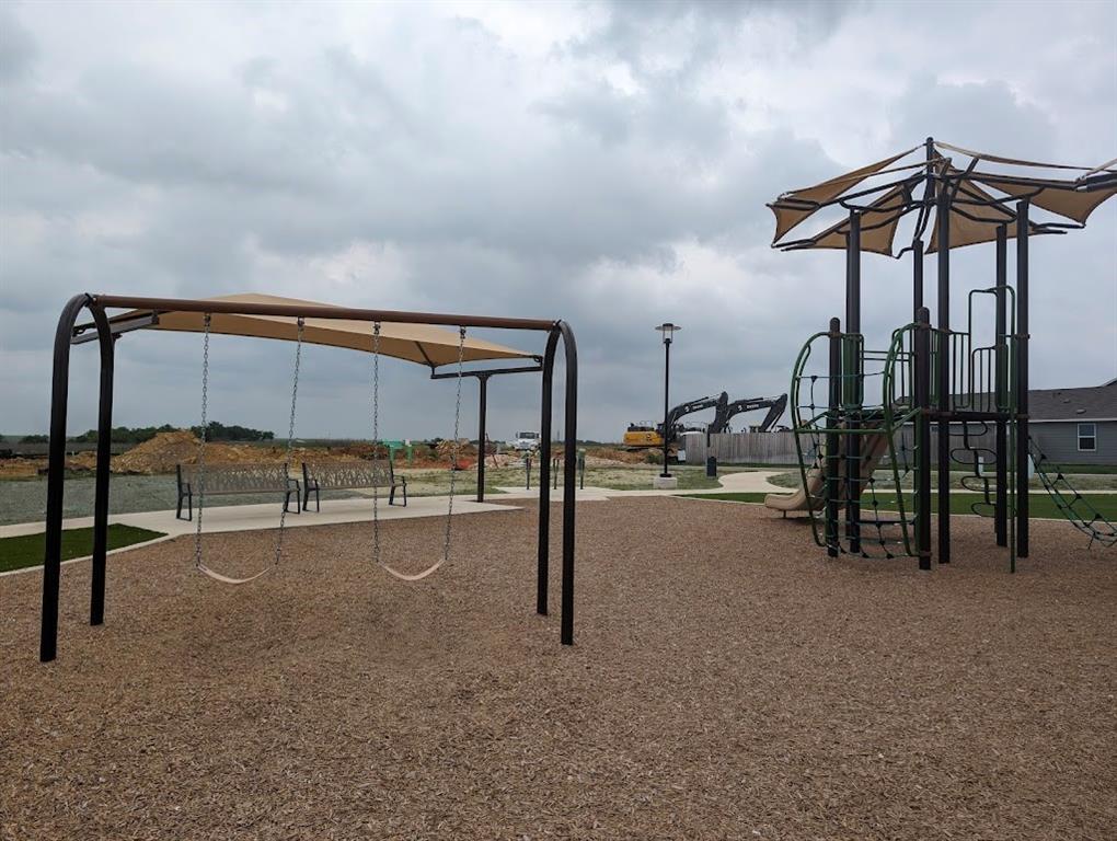 564 Rancho Del Cielo Loop Jarrell, TX 76537 - Photo 10 of 14 A community playground with swings and play structure, perfect for family enjoyment.