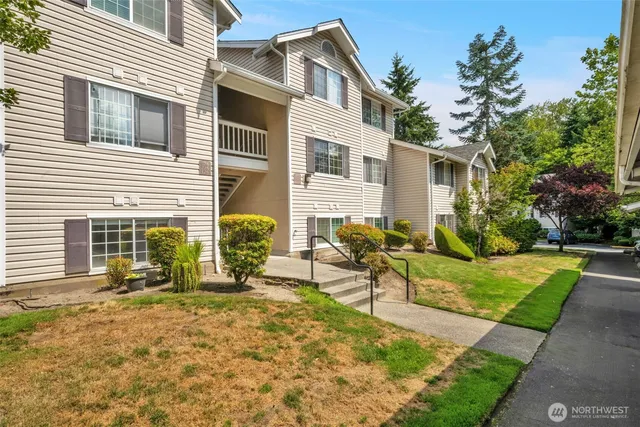 a view of a house with backyard and sitting area