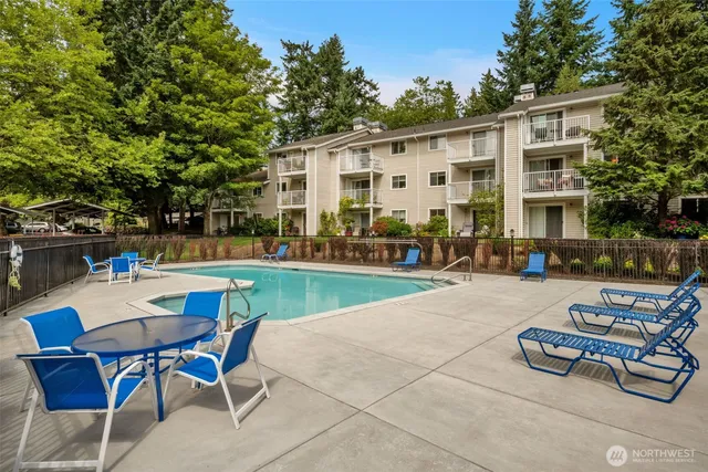 a view of a patio with table and chairs and potted plants