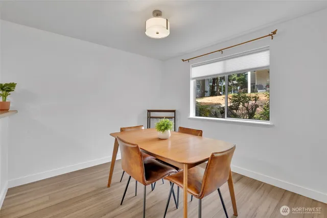 a view of a dining room with furniture window and wooden floor