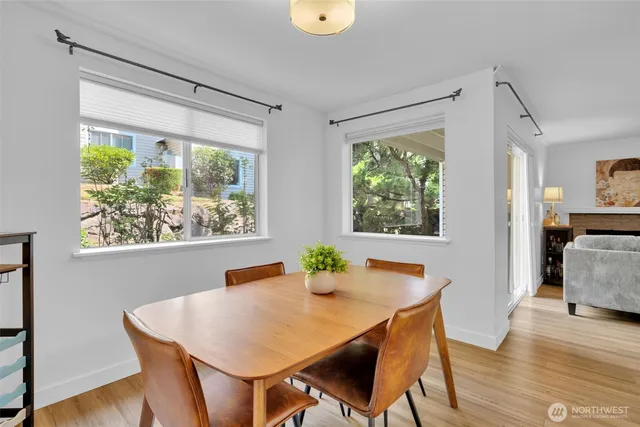 a view of a dining room with furniture window and wooden floor