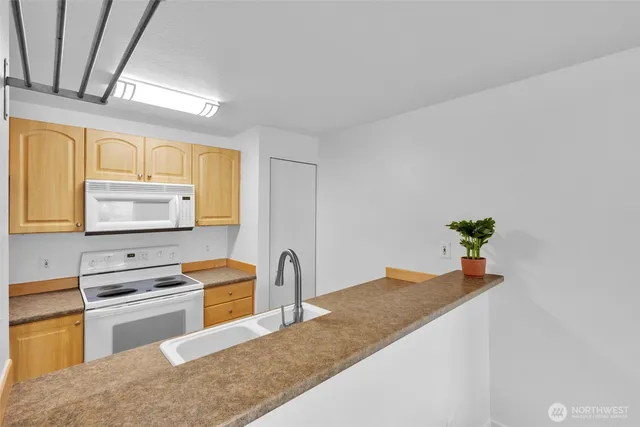 a kitchen with stainless steel appliances granite countertop a sink and a stove top oven