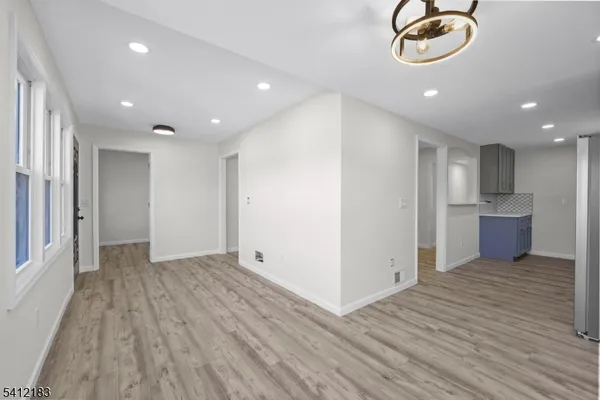 a view of room with wooden floor and window