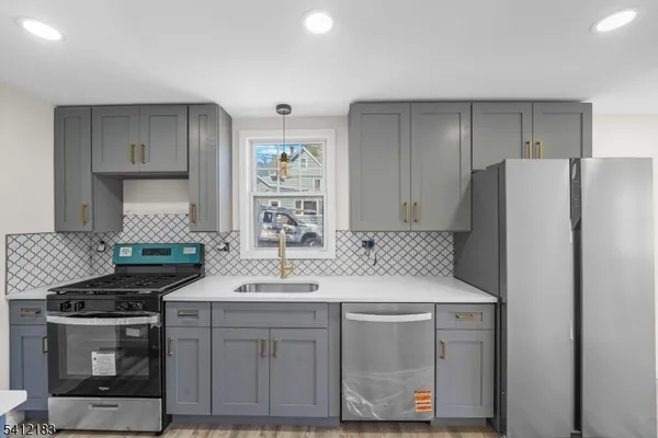 a kitchen with a sink stove and refrigerator