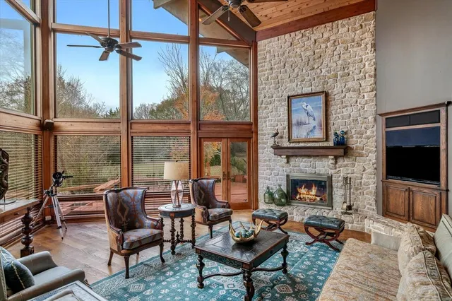 a living room with furniture a flat screen tv and a fireplace