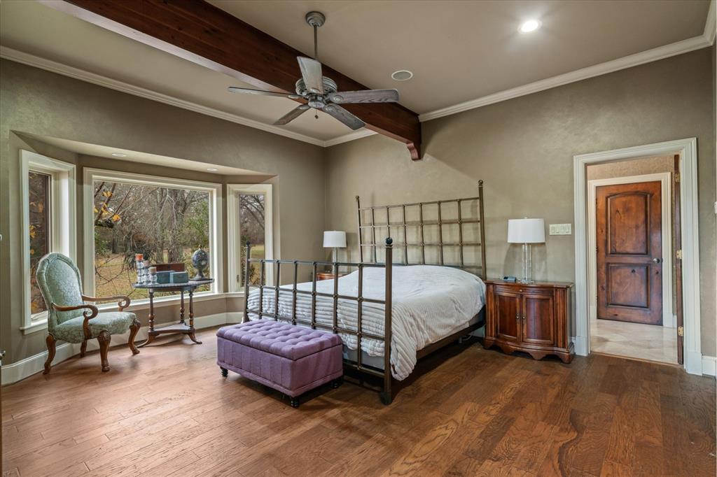 361 Fm 3227 Canton, TX 75103 - Photo 22 of 30 a bedroom with a large bed and a chandelier