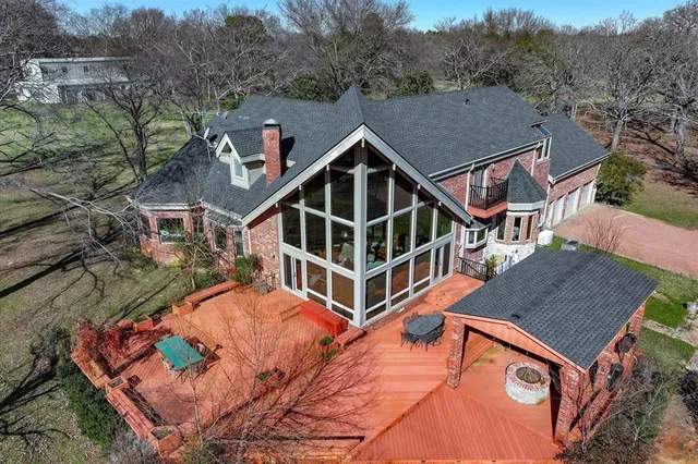 an aerial view of a house with a yard