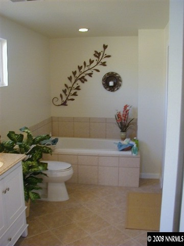 16035 Tourmaline Drive Reno, NV 89521 - Photo 8 of 9 a bathroom with a toilet a sink and bathtub