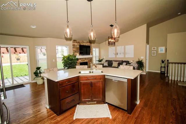 a kitchen with a sink and wooden floor