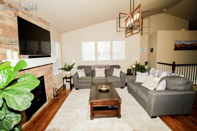 a living room with furniture fireplace and flat screen tv