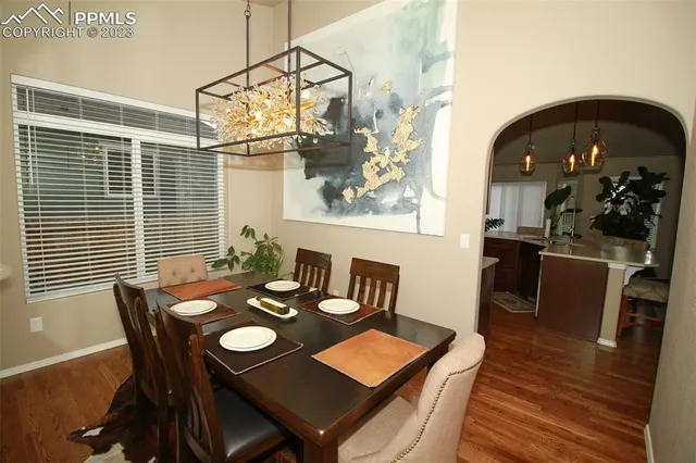 a view of a dining room with furniture and wooden floor