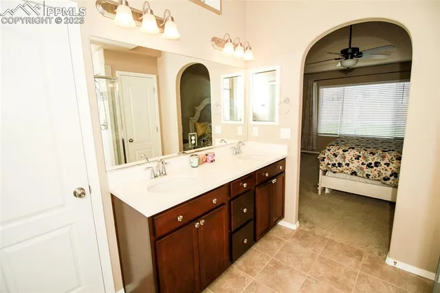 a spacious bathroom with a double vanity sink a mirror and a