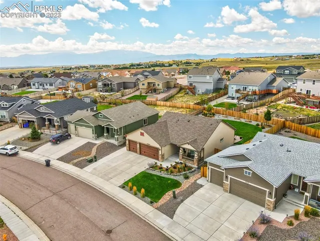 an aerial view of residential houses with outdoor space and ocean view