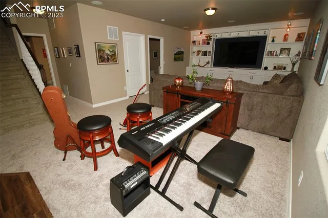 a living room with furniture and a flat screen tv