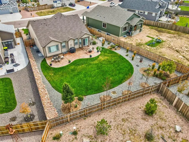 an aerial view of a house with garden space and street view