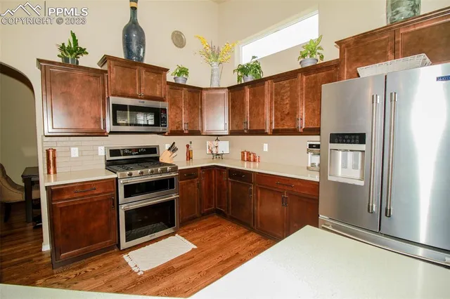 a kitchen with stainless steel appliances a stove a sink and a refrigerator
