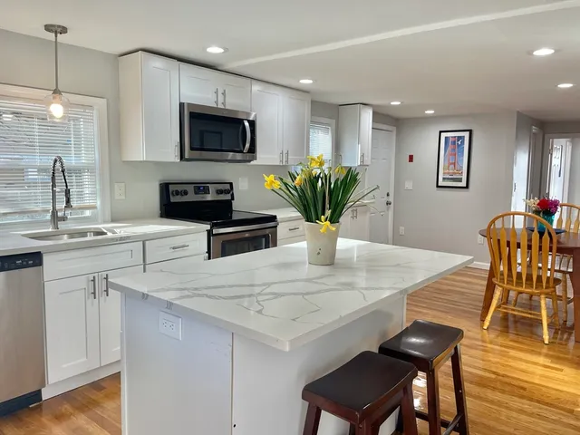 a kitchen with a table chairs sink and microwave