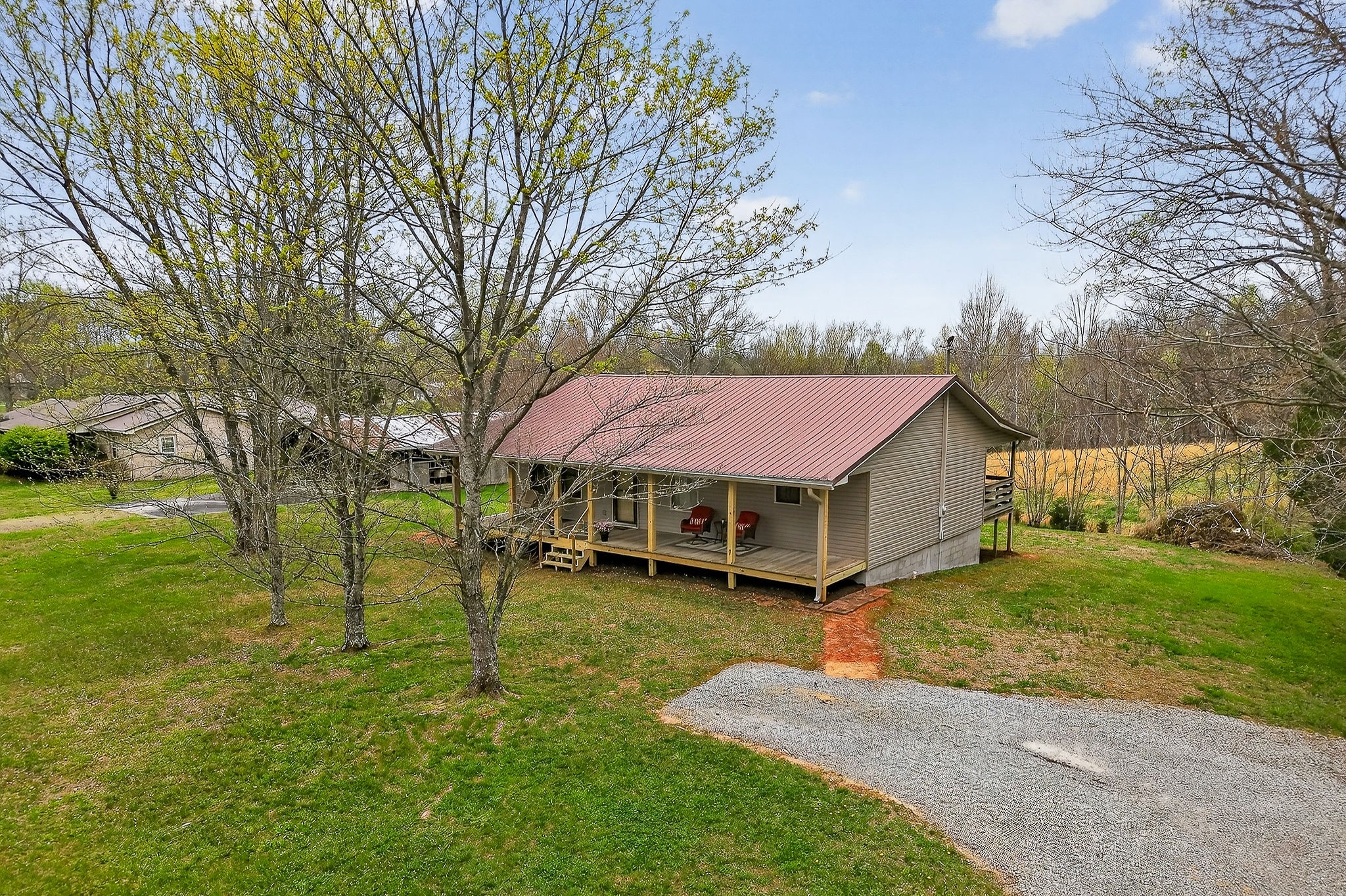 131 Poplar Springs Road Cookeville, TN 38506 - Photo 47 of 50 a yellow and red house with a big yard and large trees