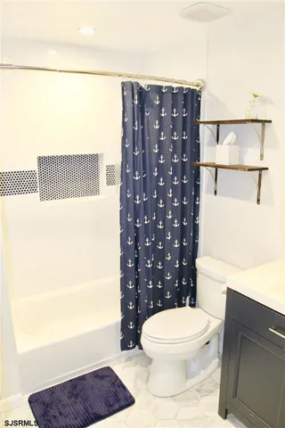 a bathroom with a toilet a sink and a shower