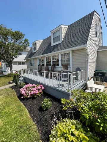 a front view of a house with a yard and fountain