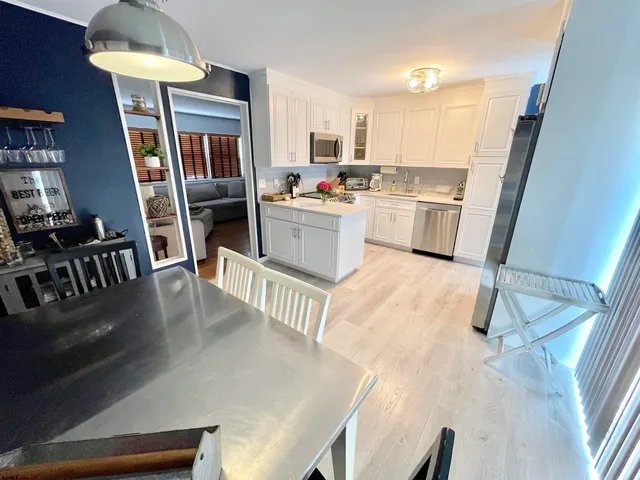 a kitchen with cabinets and wooden floor