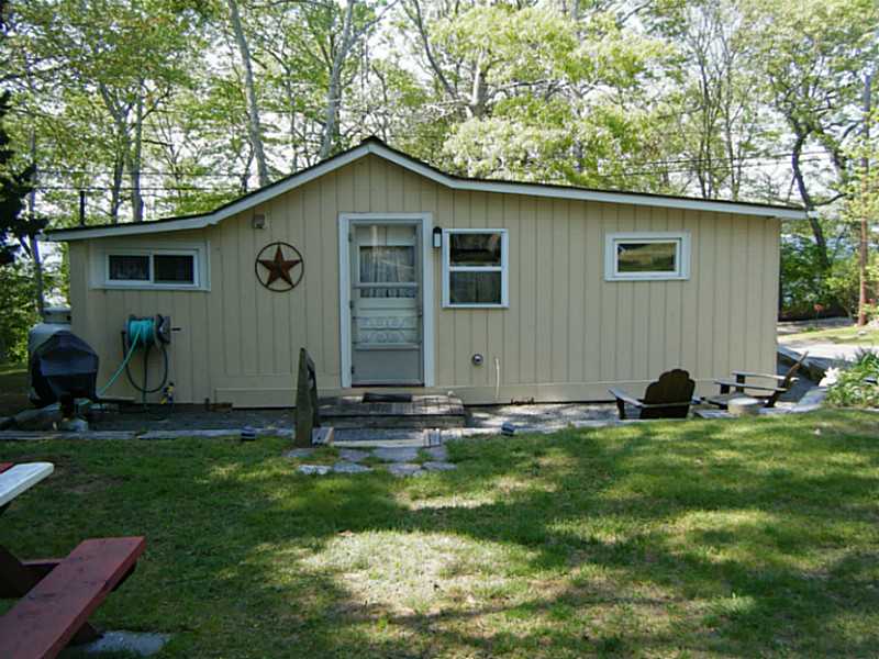108 Sanctuary Road Charlestown, RI 02813 - Photo 3 of 23 Exterior Back. Patio area with gas grill and Adirondack chairs for restful evening dinners.