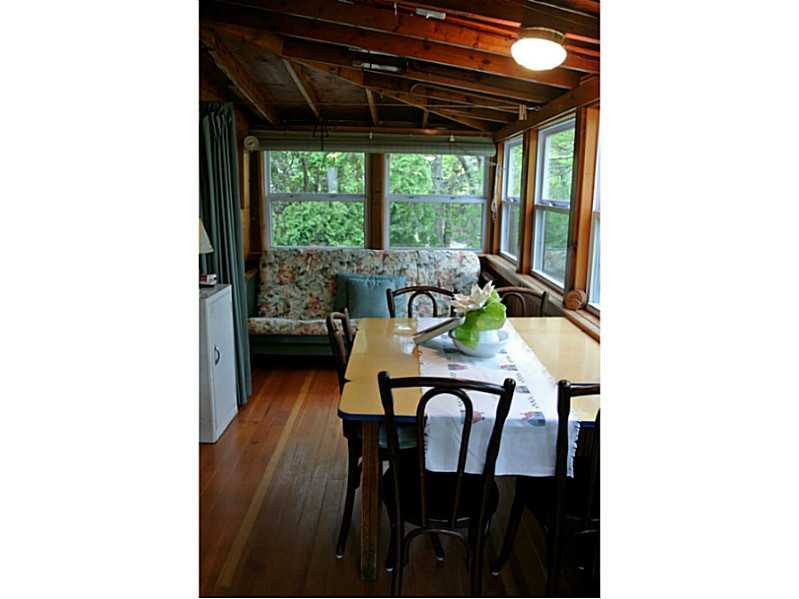 108 Sanctuary Road Charlestown, RI 02813 - Photo 9 of 23 Porch. Porch was enclosed and made a part of the living area. Futon opens to third sleeping area. See the curtain that can be drawn for privacy! Dining area overlooking front yard and Watchaug Pond.