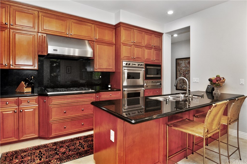 21 Catania Newport Coast, CA 92657 - Photo 13 of 31 a kitchen with stainless steel appliances granite countertop a stove a sink and a microwave