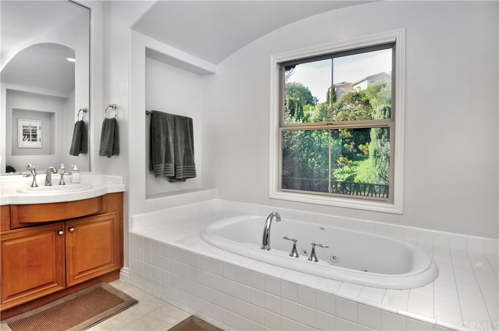 21 Catania Newport Coast, CA 92657 - Photo 23 of 31 a bathroom with a tub sink and mirror