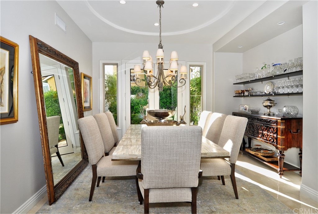 21 Catania Newport Coast, CA 92657 - Photo 7 of 31 a dining room with furniture a chandelier and wooden floor