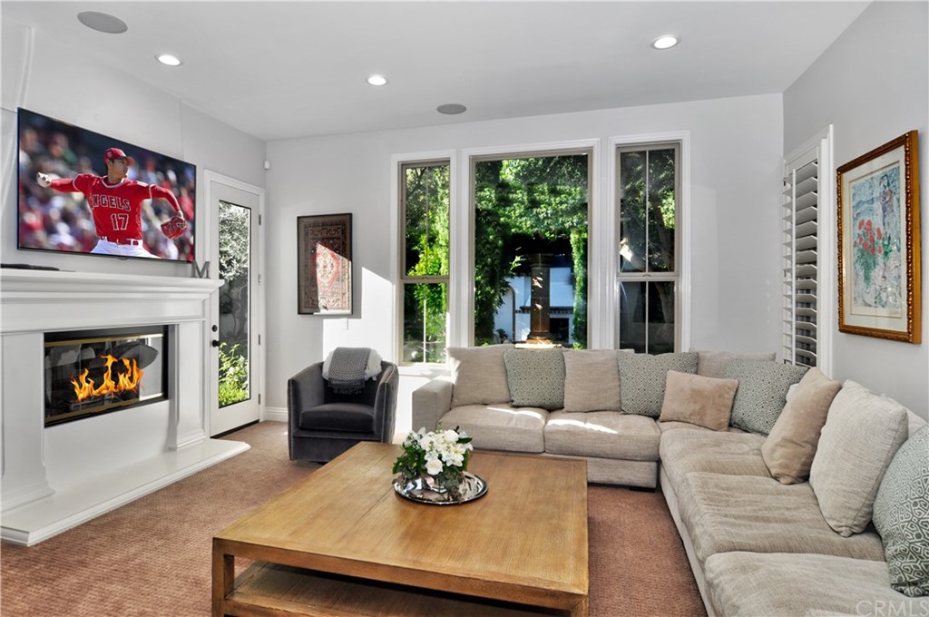 21 Catania Newport Coast, CA 92657 - Photo 8 of 31 a living room with furniture a fireplace and a large window