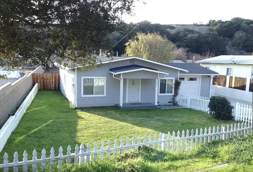 11010 Ralph Lane Salinas, CA 93907 - Photo 1 of 4 a view of a yard in front of a house with plants and large tree