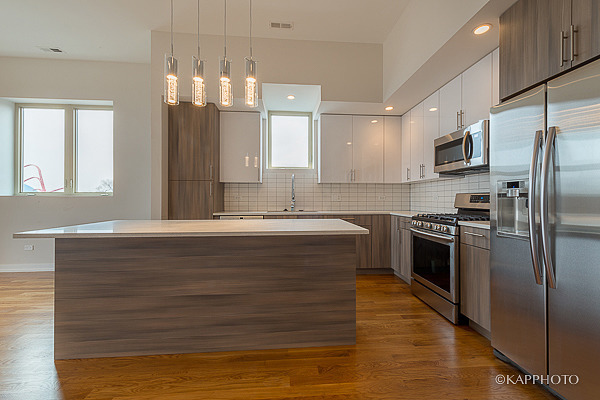 2835 West Division Street, Unit 3E Chicago, IL 60622 - Photo 7 of 25 a large kitchen with granite countertop a large counter top stainless steel appliances and cabinets
