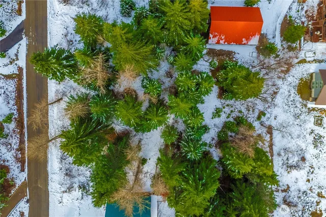 an aerial view of a house with a yard and garden