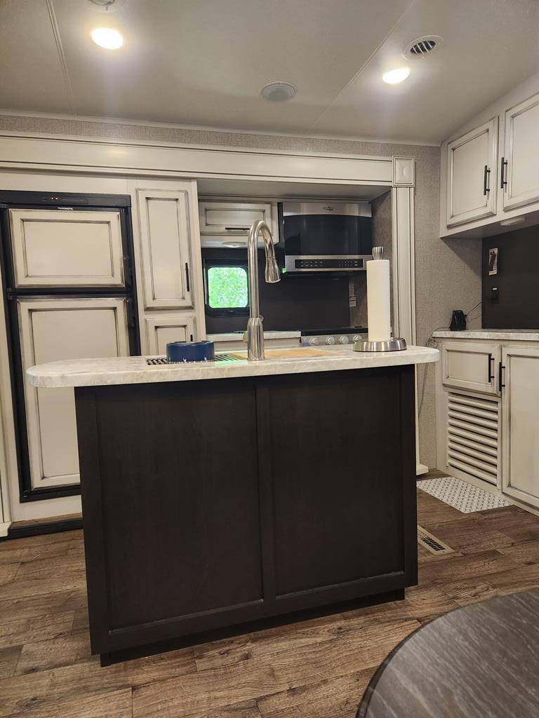 257 20th Street Ellijay, GA 30540 - Photo 13 of 29 a kitchen with kitchen island sink and wooden floor
