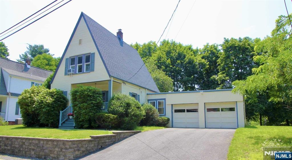 6 Cottage Place Allendale, NJ 07401 - Photo 2 of 20 a front view of a house with a yard and garage