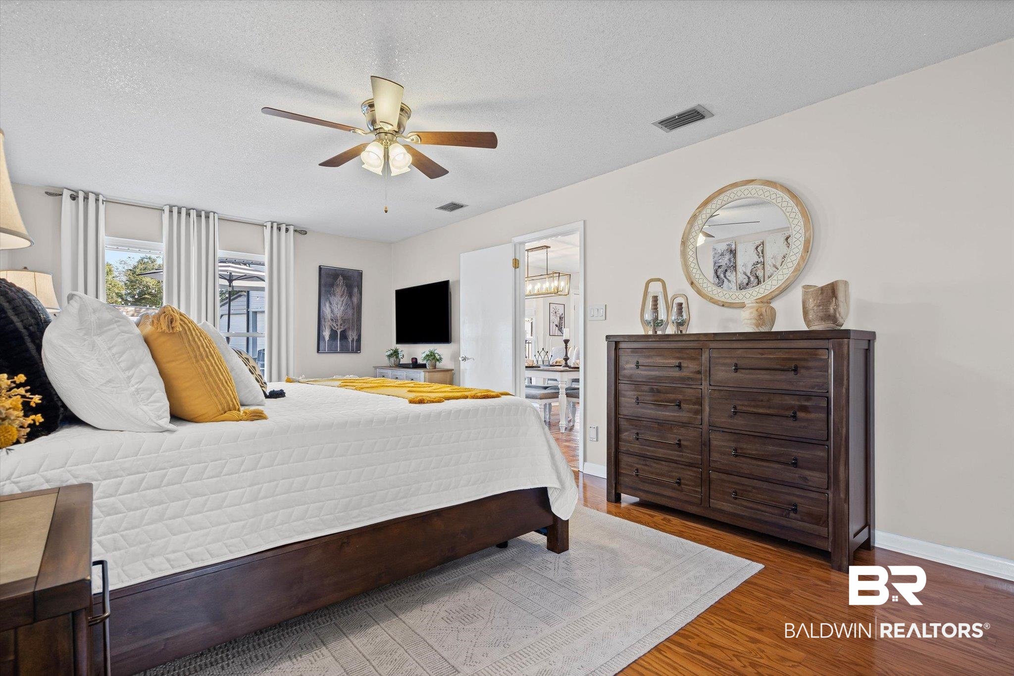 4567 Pine Avenue Saraland, AL 36571 - Photo 12 of 48 Bedroom featuring wood finished floors, a ceiling fan, and a textured ceiling