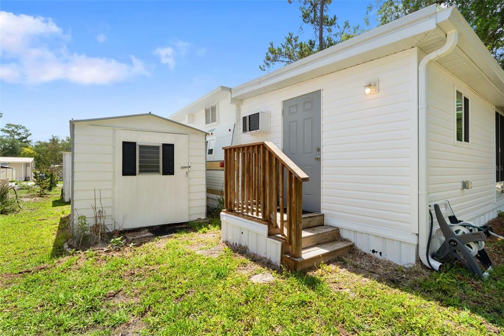 2092 Culbreath Road, Unit C52 Brooksville, FL 34602 - Photo 19 of 33 a view of a house with backyard and wooden fence