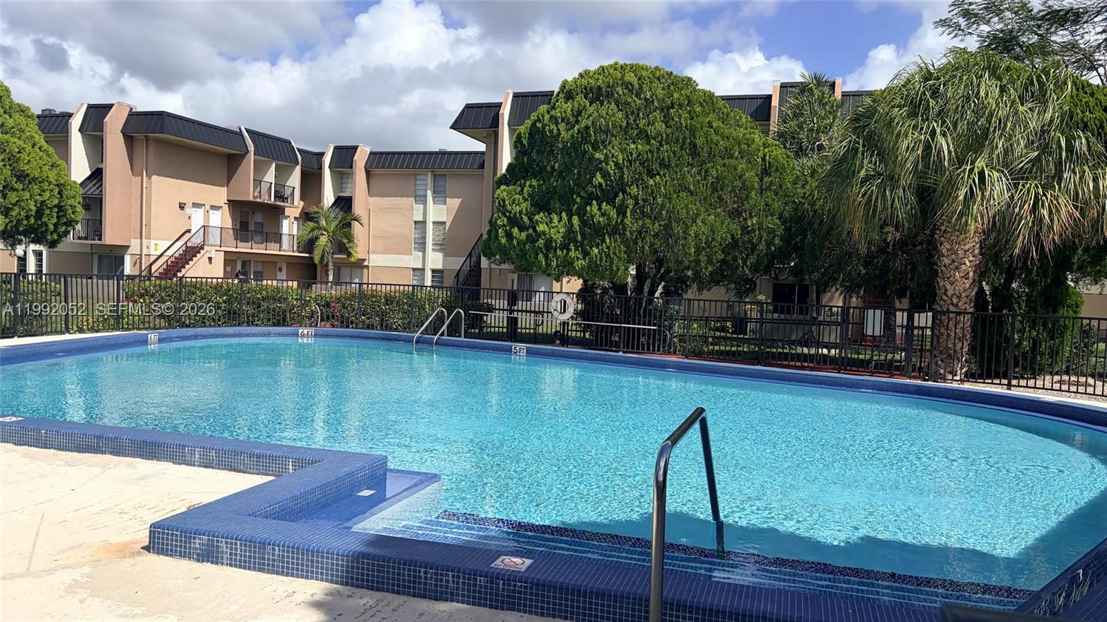 3901 Southwest 109th Avenue, Unit 8 Miami, FL 33165 - Photo 2 of 7 a view of a swimming pool with a patio