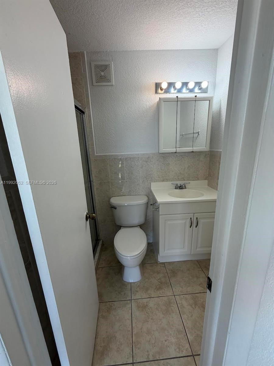 3901 Southwest 109th Avenue, Unit 8 Miami, FL 33165 - Photo 5 of 7 a bathroom with a sink toilet and a mirror