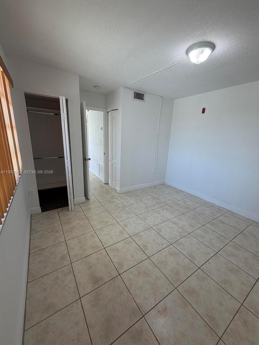 3901 Southwest 109th Avenue, Unit 8 Miami, FL 33165 - Photo 7 of 7 a view of an empty room and window