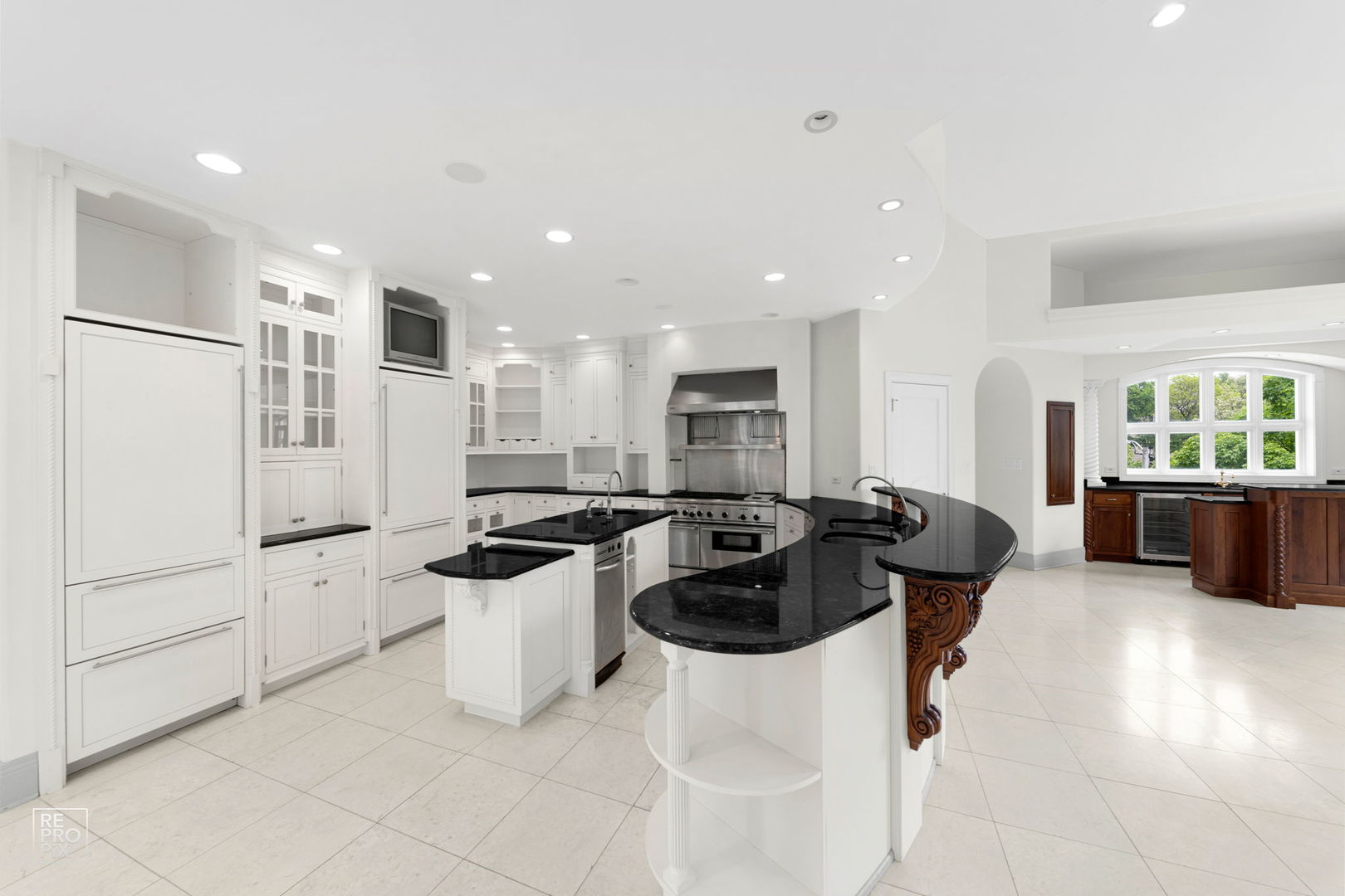 355 Flagg Court Hinsdale, IL 60521 - Photo 13 of 53 a kitchen with stainless steel appliances a refrigerator a sink a stove a microwave a dining table and chairs