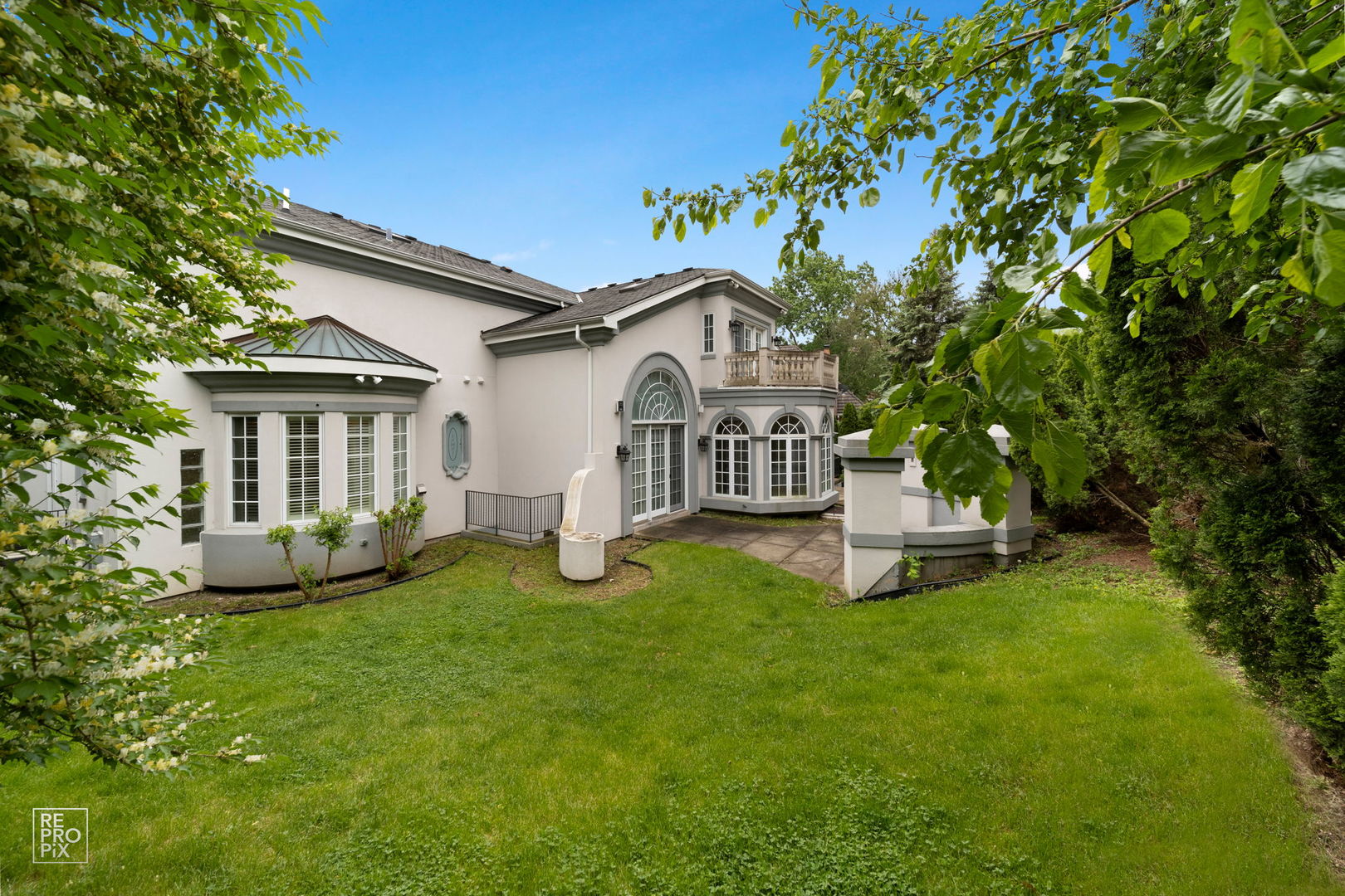 355 Flagg Court Hinsdale, IL 60521 - Photo 50 of 53 a white house with a small yard and big trees