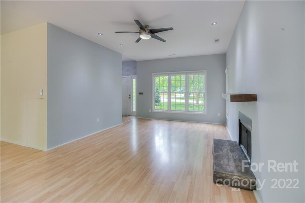 2857 Windsor Chase Drive Matthews, NC 28105 - Photo 12 of 46 wooden floor in an empty room with a fireplace