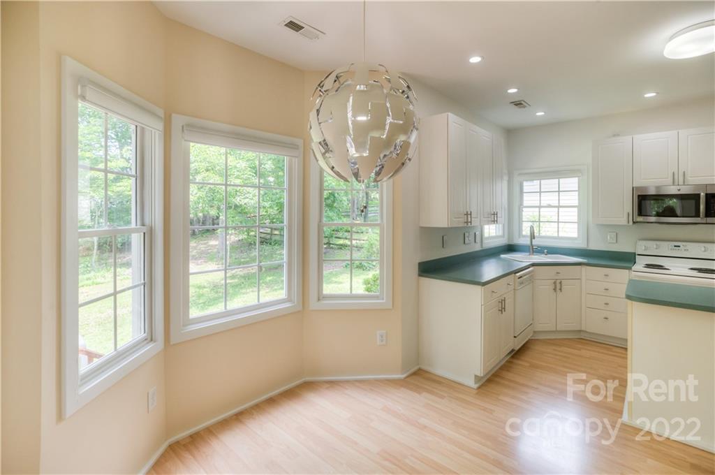 2857 Windsor Chase Drive Matthews, NC 28105 - Photo 14 of 46 a kitchen with a window wooden floor and stainless steel appliances