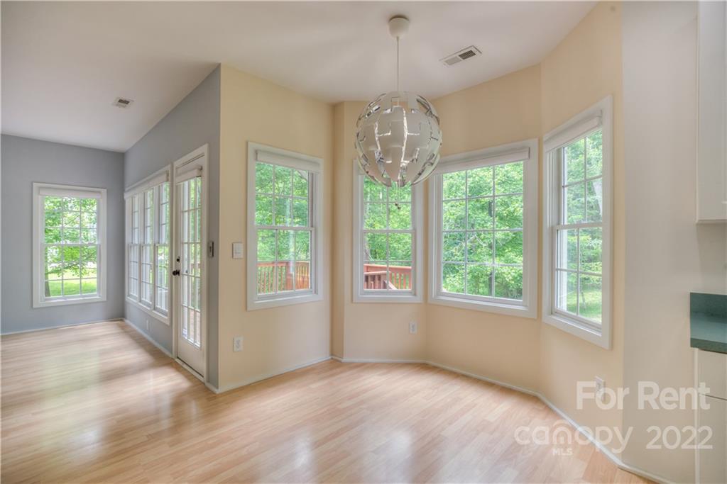 2857 Windsor Chase Drive Matthews, NC 28105 - Photo 15 of 46 a view of an empty room with wooden floor and a window
