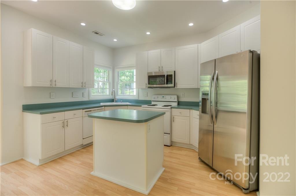 2857 Windsor Chase Drive Matthews, NC 28105 - Photo 16 of 46 a kitchen with kitchen island granite countertop appliances cabinets and a sink