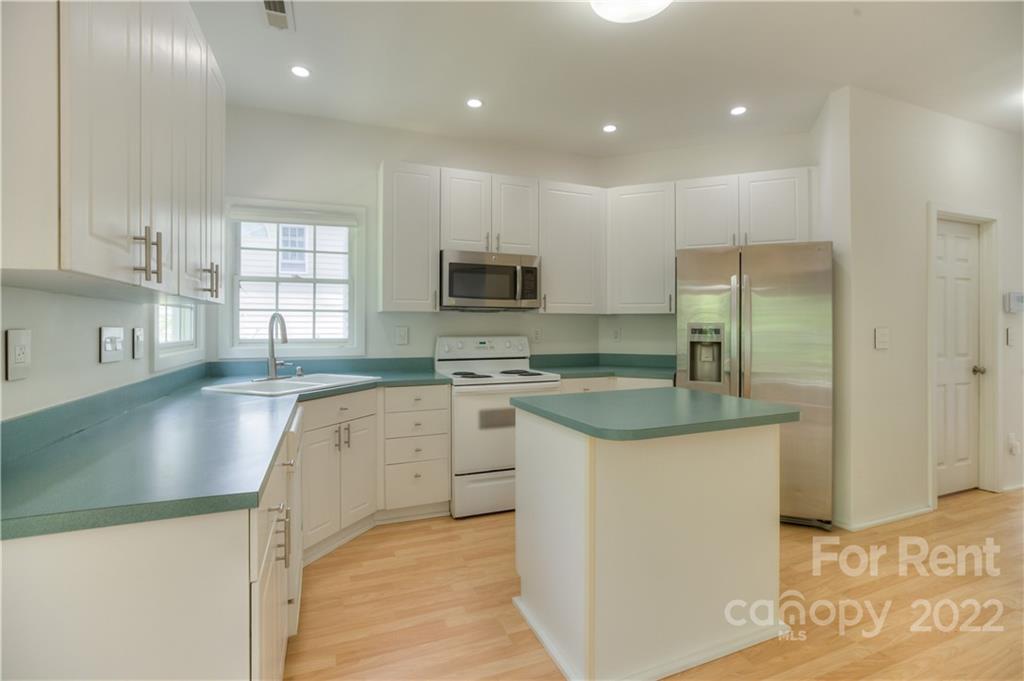 2857 Windsor Chase Drive Matthews, NC 28105 - Photo 17 of 46 a kitchen with stainless steel appliances granite countertop a sink a stove a refrigerator and a microwave